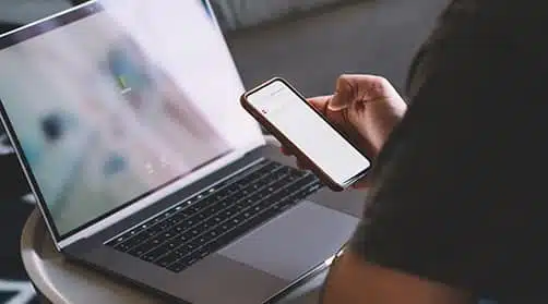 An image of a customer checking their vending machine's inventory and pricing remotely on their cell phone and laptop.